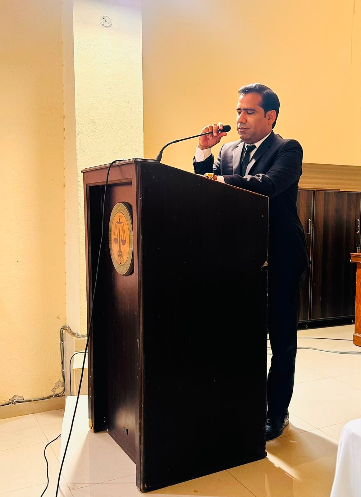 Ali Raza Wahga speaking at a podium